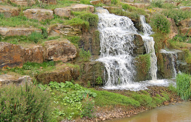 Fototapeta na wymiar A Waterfall Flowing Over a Rocky Stone Outcrop.