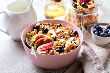Muesli with Nuts Yogurt and fresh Figs Blueberry on the gray Background.Granola Healthy Breakfast. Sweet food Dessert. Snack  Dry Diet Nutrition Concept.