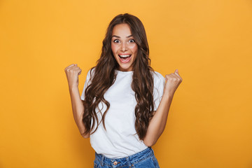 Portrait of a cheerful young girl with long brunette hair