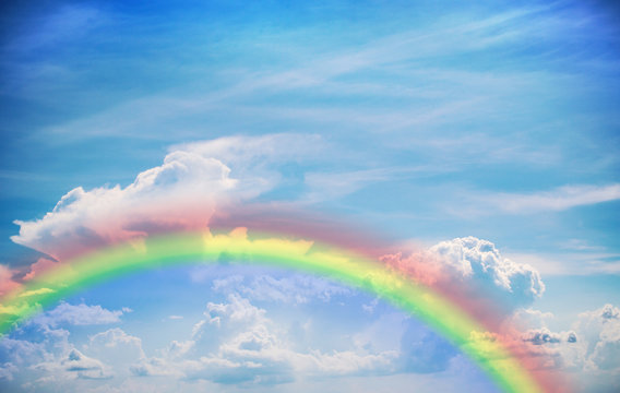 Beautiful rainbow in the sky.A photo of a sky with a rainbow background.Rainbow with white clouds over blue sky