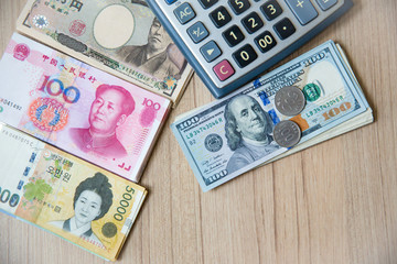 many banknote currency, yen-Japan,dollar-USA,yuan-China, euro-EU and thai baht with calculator.image for background ,wallpaper and copy space. saving and invesment for the person.dollor currency.