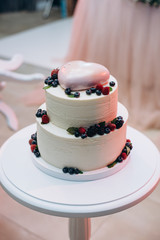 Obraz na płótnie Canvas Wedding or birthday cake with berries. Sweet pie on banquet in restaurant. 