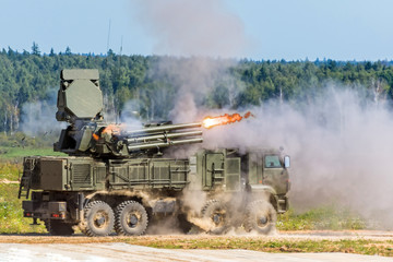 The shooting armored personnel carrier, the fighting machine is the hall of turn. The fire emanating from the barrel.