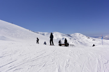 On the snow-capped peaks of  the mountain Sierra Nevada skiers and snowboarders