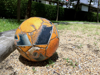 Closeup Old soccer ball on the sand © Supachai