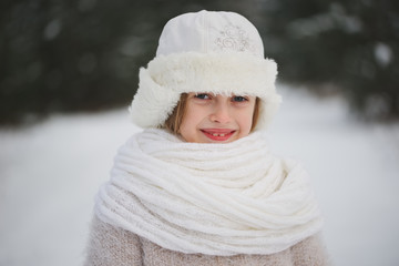 little happy beautiful girl in winter forest