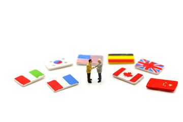 Miniature people : Businessman with international flag using for concept of United Nations Day.