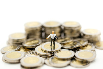 Miniature people : Businessman and Boss with stack of coins using for concept of Boss Day.