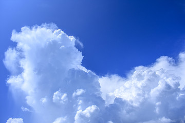 dense white clouds in the blue sky