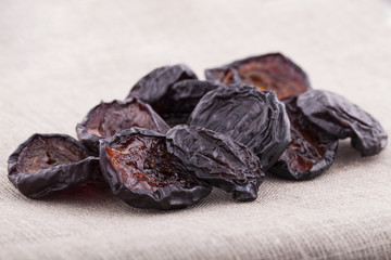 Dried plums on textile background