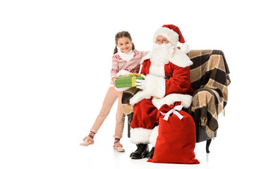 santa presenting christmas gift to happy child isolated on white