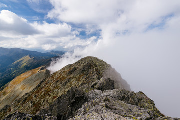 Fototapeta na wymiar Cloud covered mountain peaks in the High Tatra