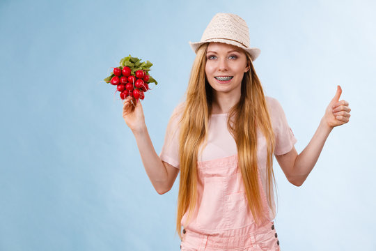 Happy woman holding radish