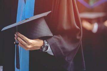graduation,Student hold hats in hand during commencement success graduates of the...