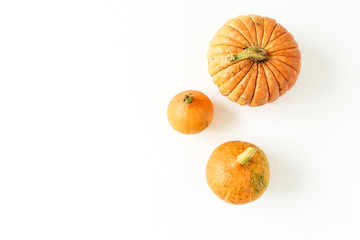 Pumpkins on white background. Fall autumn concept. Flat lay, top view.