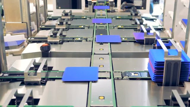 Innovation technology. Blue solar module cells are collected into columns and getting put into ledges.