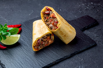 Mexican burrito with meat on black