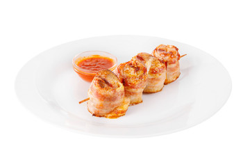Shish kebab, beef, lamb, pork, chicken in bacon grilled meat, barbecue, without garnish on a plate, isolated on white background, ketchup, tomato red sauce. Side view For the menu