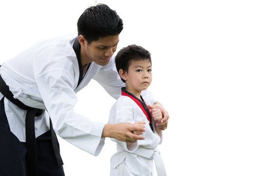 Taekwondo master black belt teaching kid to fight guard on white background