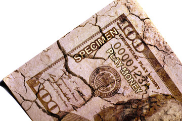 Cracked US paper dollar currency on isolated white background