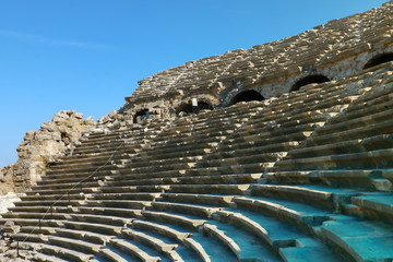 the ruins of an ancient stone amphitheater on a sunny day