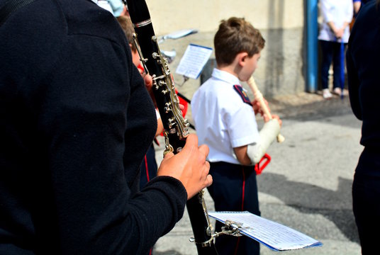 Street musicians play folk music at city square.