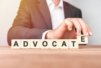 Man made word ADVOCATE with wood blocks