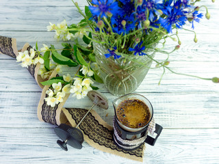 Still life with cornflowers, coffee and jasmine flowers.