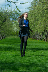 Beautiful young girl walking in spring Park