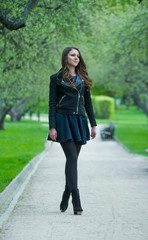 Fototapeta premium Beautiful young girl walking in spring Park