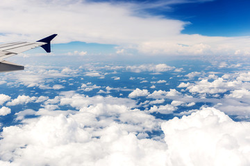 Fototapeta premium Looking through window aircraft during flight in wing with a blue sky
