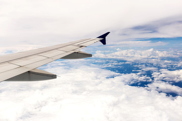 Looking through window aircraft during flight in wing with a blue sky