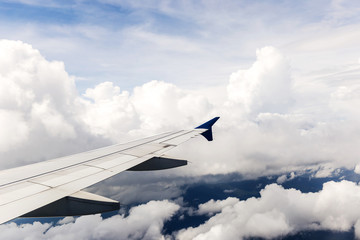 Looking through window aircraft during flight in wing with a blue sky
