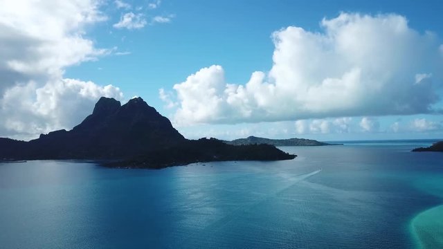 Aerial footage from a drone of blue lagoon and Otemanu mountain at Bora Bora island, Tahiti, French Polynesia, South Pacific Ocean (Bora Bora Aerial)
