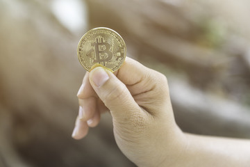 woman holding bitcoin in hand