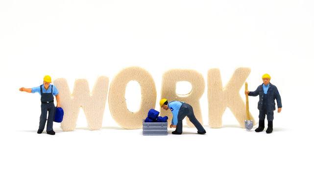 Work Word Wooden Letters And Worker Models On White Background. Blue Collar Work Concept Scene.