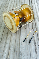 The janggu or janggo or sometimes called seyogo means slim waist drum is the most representative drum in traditional Korean music. Traditional Korean drum with beating Sticks on the wooden table.