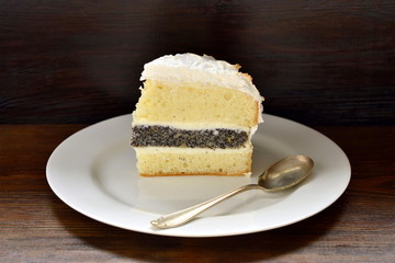 Lemon poppy seed sponge cake with curd cream and meringue