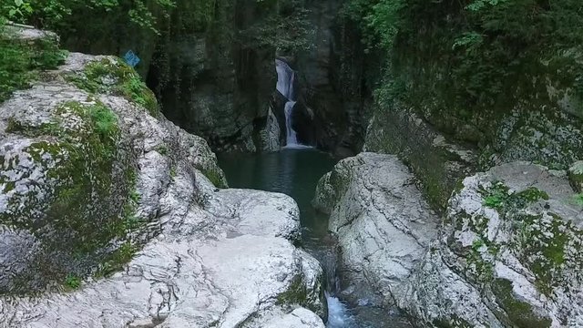 A deserted mysterious waterfall of a mountain river. The devil's font is one of the Agur waterfalls in Russia, Sochi.
