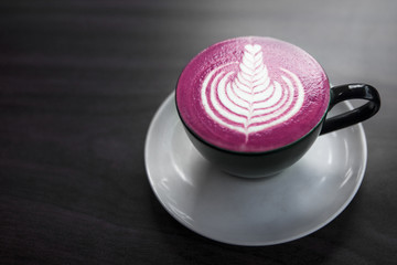 Fototapeta na wymiar trendy pink beetroot latte is on the gray wooden background