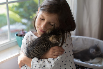 A girl holding kittens.