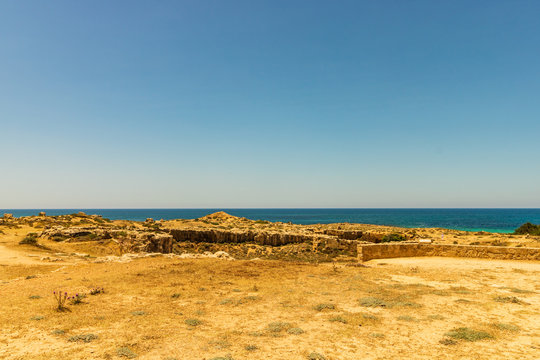 Ruins and columns of the ancient city of Paphos, Cyprus. Mediterranean Sea in the background. 