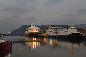 Fototapeta na wymiar After sunset - Passenger ships and car ferries at quay in Bronnoysund Northern Norway