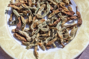 Close-up top shoot of string beans dried under the sunlight on the plate