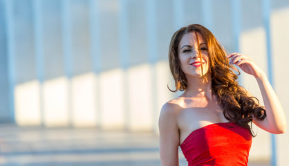 Beautiful young girl in red walking around the Mall