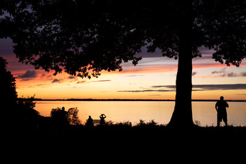 Sunset silhouette with people admiring the sunset