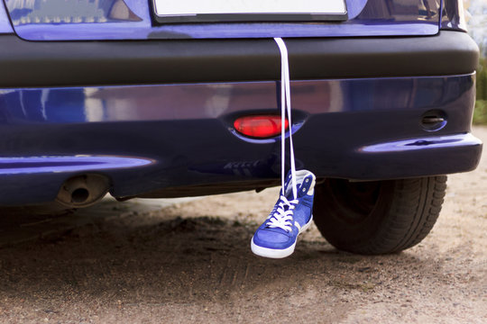 the car is blue. in the trunk of a hanging sneaker for running. more zanimatsya sports