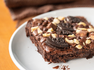 Cookies homemade and cream with chocolate brownies and almond on white dish