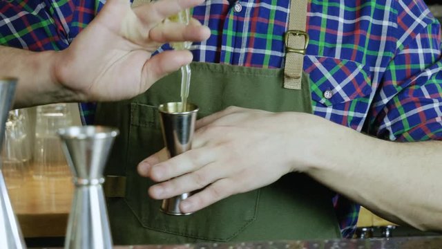 The barman measuring of alcohol for drinking. The bartender making a sicilian cocktail. 4K