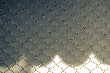 Fototapeta premium Creative abstract shadows of chain link fence wire mesh steel metal isolated on color background. Art design gate made. Prison barrier, secured property. Abstract concept graphic element